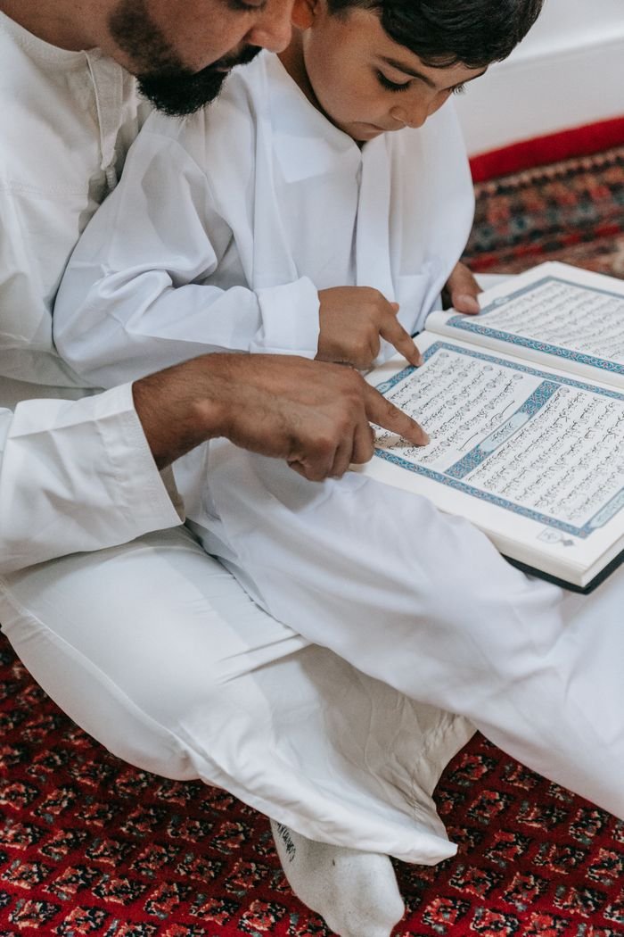 creative A father and son reading the Quran together, symbolizing faith and tradition.